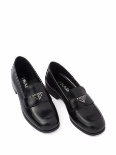 Prada logo-plaque Leather Loafers - Farfetch Luxury Flat Heel Slip-ons For Formal Occasions, Luxury Round Toe Slip-ons For Work, Luxury Calf Leather Slip-on Shoes, Luxury Formal Slip-ons With Flat Heel, Luxury Black Slip-ons With Round Toe, Sleek Black Calf Leather Loafers, Luxury Slip-on Leather Shoes With Rubber Heel Cap, Black Calf Leather Slip-ons For Office, Luxury Slip-ons For Work