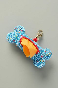 a blue dog toy with an umbrella attached to it's side on a gray surface