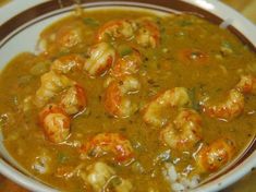 a bowl filled with shrimp and rice on top of a table