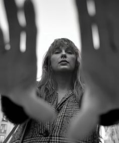 a woman holding her hands up in the air