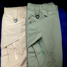 two pairs of khaki pants sitting next to each other