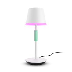 a white lamp with a pink and green light on it's side next to a black base