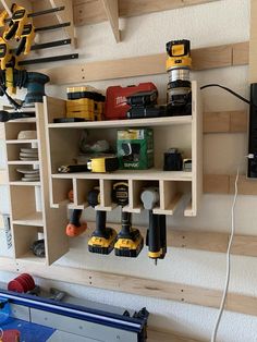 a workbench with tools hanging from it's wall and on the shelves