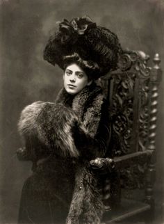 an old black and white photo of a woman in fur