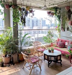 a balcony with lots of potted plants and wicker furniture