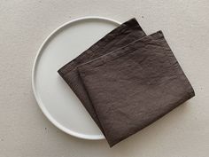 two napkins sitting on top of a white plate