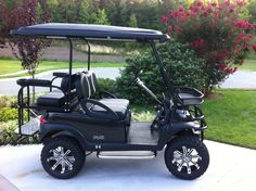 a black golf cart parked in front of a house