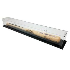 a baseball bat in a glass display case on a white background with an inscription that reads,