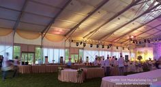 the inside of a large tent with tables and chairs set up for an outdoor function