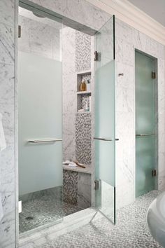 a bathroom with marble walls and floor