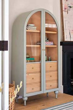 an arch - shaped bookcase with drawers is featured in this article