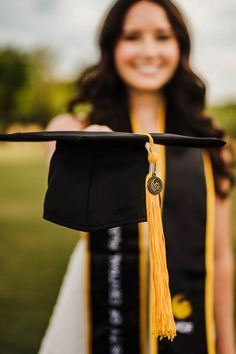 a woman holding a graduation cap and tassel