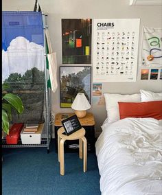 a bed room with a neatly made bed and pictures on the wall