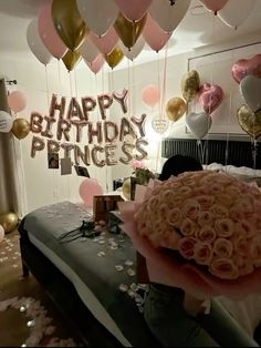 a room filled with balloons and pink roses in the center, along with happy birthday princess letters on the wall