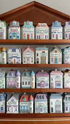 a wooden shelf filled with lots of small houses