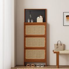 a wooden cabinet sitting next to a white wall