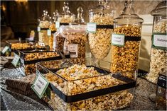 a table filled with lots of different types of popcorn and candies on top of it