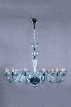 a glass chandelier with five lights hanging from it's center and four arms