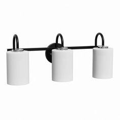 three light bathroom fixture with black finish and white cylindrical shades on the top, in an industrial style