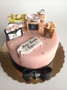 a birthday cake decorated with shopping bags and shoes