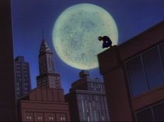 a man standing on top of a tall building in front of a large full moon