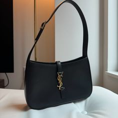 Gently Worn. Minor Scratches. Bought It At The New York Soho Store. Now Retail Is $2400. With Receipt, No Dust Bag. * Saint Laurent "Le 5 7" Monogram Hobo Bag In Smooth Calf Leather. * Shoulder Bag That Tucks Under The Arm For A Sleek, Retro-Chic Look. * Adjustable Shoulder Strap, 8" Drop * Center Flap Top With Ysl Logo, Tab Closure. * Gold-Tone Hardware. * Interior, Zip Pocket. * Approx. 9"H X 6.2"W X 2.5"D. * Weighs Approx. 0.7lbs/ 0.3kg. * Made In Italy. Bag Saint Laurent, Saint Laurent Bags, Ysl Logo, Hobo Shoulder Bag, Saint Laurent Bag, Retro Chic, Hobo Bag, Smooth Leather, Leather Shoulder Bag