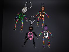 six pairs of scissors with beaded handles are shown in the shape of people's legs