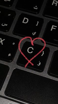 a computer keyboard with a red heart drawn on it's key and the letter c