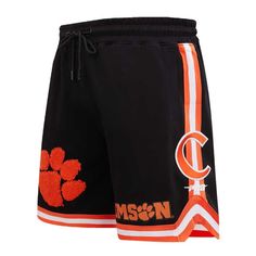 Upgrade your collection of Clemson Tigers gear by picking up these Classic shorts from Pro Standard. On the front of both legs and on each side, there are several eye-catching graphics and appliques that are sure to emphasize your unwavering passion. The drawstring-adjustable elastic waistband ensures you'll be able to maintain a comfortable fit throughout every wear, especially on Clemson Tigers game day. One rear zippered pocket Elastic waistband withdrawstring Machine wash, tumble dry low Off Collegiate Style Short Bottoms For Game Day, Collegiate Cotton Athletic Shorts, Collegiate Cotton Bottoms For Sports Events, Classic Shorts, Clemson Tigers, Game Day, Tigers, Appliques, Zipper Pocket