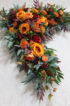 an arrangement of flowers arranged on the floor