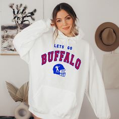 Buffalo Womens Sweatshirt, Buffalo Football Hoodie, Vintage Buffalo Sweatshirt, Retro Buffalo Football Crewneck, Buffalo Hoodie Women This is the perfect hoodie for keeping warm in style. This crewneck is knit using tubular knit, which reduces fabric waste and makes your piece look better than ever! The ribbed knit collar adds an extra bit of flare to this piece, making it look highly elastic and helping it retain its shape. This product is SUPER soft and SUPER comfy, so it's perfect for tailgat White Hooded Sweatshirt For Fan Gear, White Fleece Hoodie For Fan Gear, White Long Sleeve Hoodie With Team Name, White Hoodie With Ribbed Cuffs For Game Day, White Hoodie Sweatshirt For Fan Gear, White Hoodie Sweatshirt Fan Gear, White Hoodie Sweatshirt For Fans, White Fleece Hoodie With Team Name, White College Fan Apparel Hoodie