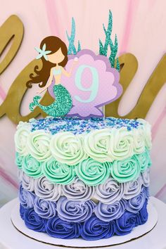 there is a cake that has been decorated with the number nine on it and mermaid tail