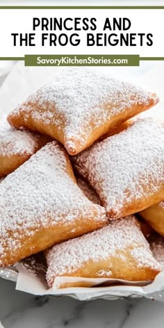 princess and the frog beignets are piled on top of each other with powdered sugar