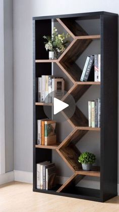 a book shelf with books and plants on it in front of a wall mounted clock