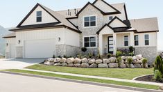 a large house with two garages and landscaping