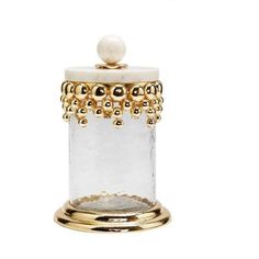 a white and gold container with pearls on the top, sitting in front of a white background