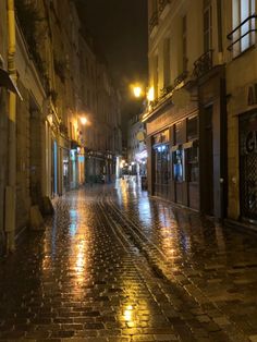 an empty city street at night in the rain