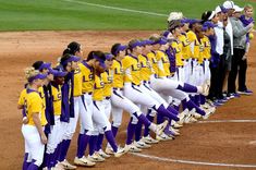 the softball team is lined up on the field