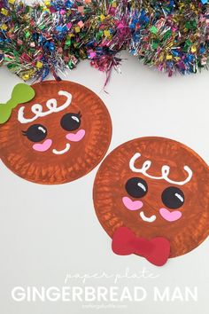 paper plate gingerbread man craft for kids with tinsel on the top and colorful streamers in the background