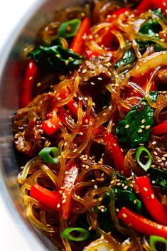 a pan filled with stir fry vegetables on top of a table