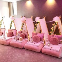 a row of pink couches with pom - poms on them