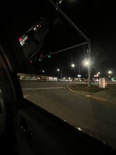 an empty street at night with traffic lights