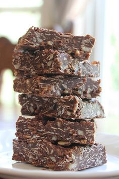 four pieces of chocolate oatmeal no - bake bars stacked on top of each other