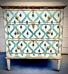 an old dresser with blue and white tiles on it