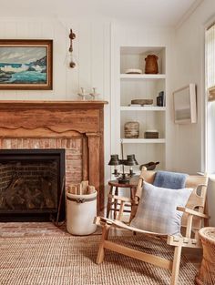 a living room filled with furniture and a fire place in front of a painting on the wall