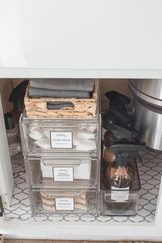 the inside of a refrigerator with clear containers and labels on it's door handles