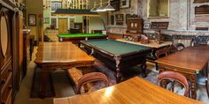 a pool table and some chairs in a room