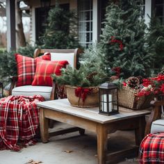 a christmas porch decorated for the holiday season with red and white plaid pillows, pine cones, evergreens, and other greenery