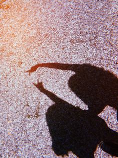 the shadow of a person holding a skateboard