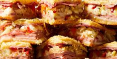 several sandwiches stacked on top of each other with meat and cheese in the middle,